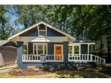 Charming renovated home with a freshly painted exterior, inviting porch, and well-manicured front yard at 943 Rose Sw Cir, Atlanta, GA 30310