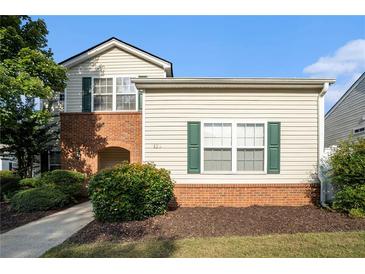 Charming two-story home with classic siding and a welcoming brick facade, showcasing curb appeal at 139 W Oaks Pl, Woodstock, GA 30188