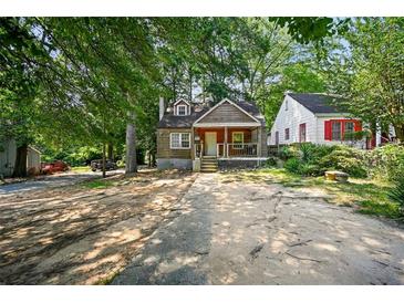 Charming bungalow with a front porch and mature trees at 1876 Madrona Street Nw St, Atlanta, GA 30318
