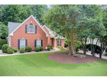 Charming brick home with well-manicured lawn and mature trees offering curb appeal at 3030 Larkspur Ct, Cumming, GA 30041