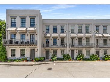 Charming townhomes with awnings and beautiful landscaping offer inviting curb appeal at 304 Stonemont Dr, Atlanta, GA 30305