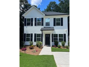 Charming two-story home with white siding, black shutters, and manicured front yard, perfect for Gathering living at 5350 Mercedes Dr, Cumming, GA 30041