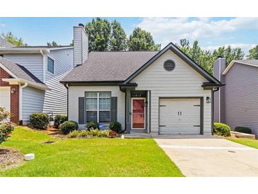 Charming home featuring a red front door, an attached garage, and well-manicured front lawn at 1269 Gates Se Cir, Atlanta, GA 30316