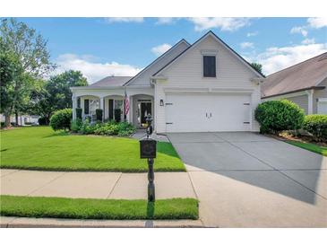 Charming single-story home with manicured lawn and attached two-car garage on a sunny day at 4140 Prince Charles Dr, Duluth, GA 30097