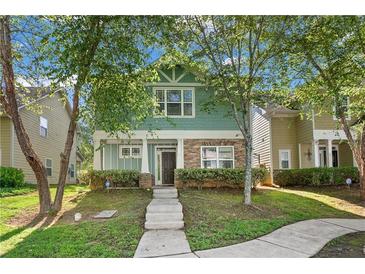 Charming two-story home with green siding and stone accents at , Conyers, GA 30012