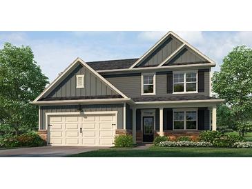 Charming two-story home with a two-car garage, covered entry, and beautifully landscaped front yard at 915 Sundown Pt, Villa Rica, GA 30180