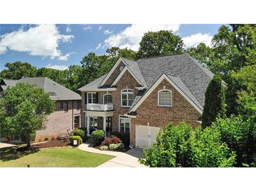 Brick two-story home with a manicured lawn and mature landscaping offers curb appeal at 5059 Belair Bluff Se Ct, Smyrna, GA 30126