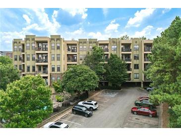 View of apartment building with parking area and landscaping at 425 Chapel Sw St # 1211, Atlanta, GA 30313
