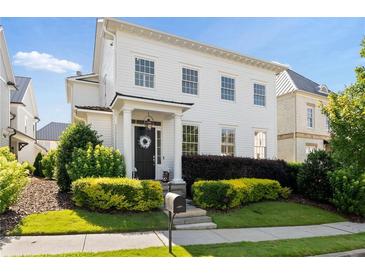 Charming two-story home featuring a covered entrance, complemented by manicured shrubs and a well-maintained lawn at 6820 Colfax Ave, Cumming, GA 30040