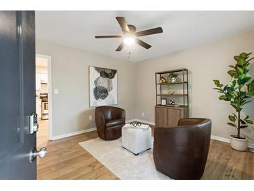 Bright sitting area featuring hardwood floors, stylish decor, and natural light streaming through the doorway at 2775 Belleau Se Ln, Atlanta, GA 30316