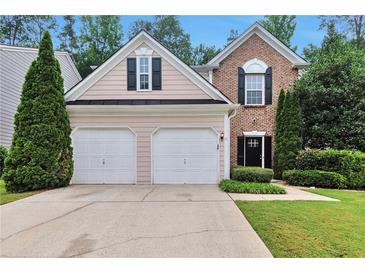 Charming home with a two-car garage, well-manicured lawn, and mature trees at 3686 Claredun Ct, Cumming, GA 30040
