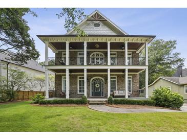 Charming two-story brick home featuring dual front porches with stately columns and manicured landscaping at 1363 Sylvan Ne Cir, Brookhaven, GA 30319