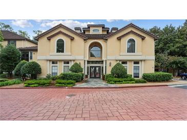 Beautiful condo building with arched windows, well-manicured landscaping, and inviting entrance at 3777 Peachtree Ne Rd # 1216, Atlanta, GA 30319
