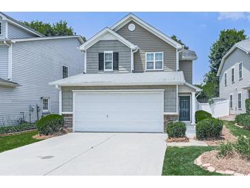 Charming two-story home with a two-car garage, stone accents, and a well-maintained front lawn at 232 Oconee Way, Canton, GA 30114
