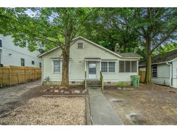 Charming single-story home with a covered porch and mature trees providing shade at 724 Bellemeade Nw Ave, Atlanta, GA 30318