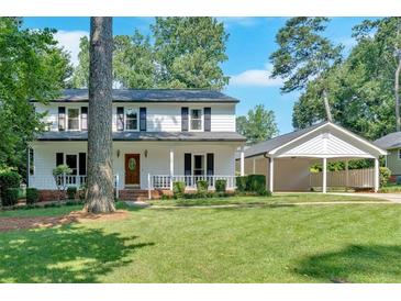 Charming two-story home with a well-manicured lawn and convenient covered parking at 1406 Arden Sw Dr, Marietta, GA 30008