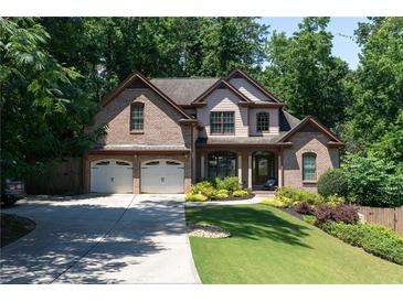 Charming two-story brick home featuring a well-manicured lawn and a two-car garage at 2015 Buford Dam Rd, Buford, GA 30518