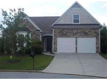 Charming single-Gathering home with stone accents, well-maintained lawn and two-car garage at 5252 Inverness Ct, Douglasville, GA 30135