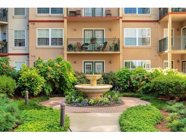 Attractive condominium exterior with fountain, beautiful landscaping and multiple balconies at 230 E Ponce De Leon Ave # 116, Decatur, GA 30030