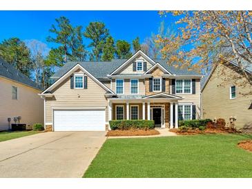 Charming two-story home with a well-manicured lawn, attached garage, and a welcoming entrance at 173 Northshore Xing, Dallas, GA 30157