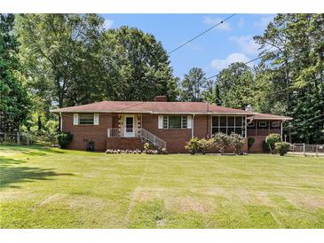 Charming brick ranch home with a well-manicured front lawn and a inviting entryway at 2247 Cypress Ave, Morrow, GA 30260