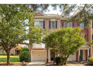 Charming brick townhouse with a one-car garage and mature trees at 5710 Waters Edge Trl, Roswell, GA 30075