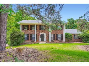 Beautiful two-story brick home with stately columns and a well-manicured front lawn at 965 Grimes Bridge Rd, Roswell, GA 30075