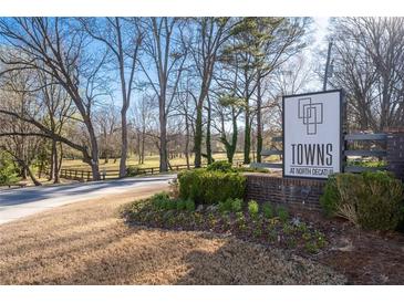 A well-manicured entrance sign for 'Towns at North Decatur' welcomes visitors into the community at 852 Constellation Dr, Decatur, GA 30033