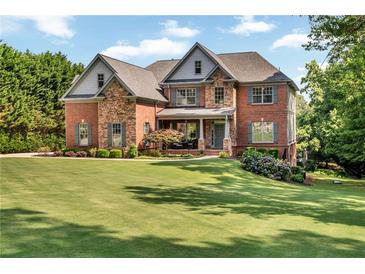 Beautiful brick two-story home with manicured lawn and tasteful landscaping at 7125 Heard Rd, Cumming, GA 30041
