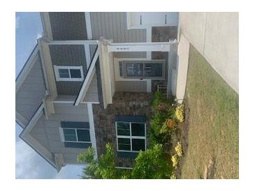 Charming two-story home with stone accents, landscaping, and inviting front entrance at 4480 Merrigold Way, Fairburn, GA 30213