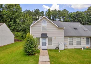 Inviting two-story home with a well-maintained lawn and charming curb appeal in a lush, green neighborhood at 6178 Field Stone Dr, Douglasville, GA 30134
