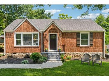 Charming brick home with a manicured lawn, inviting front entry, and a cozy seating area at 2432 Saint Patrick Se St, Atlanta, GA 30317