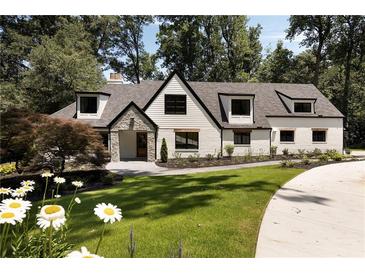 Stunning two-story home featuring a modern painted brick facade and professionally landscaped front yard at 1155 Peachtree Battle Nw Ave, Atlanta, GA 30327