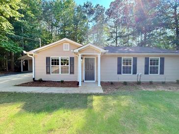 Charming single-story home featuring a well-maintained lawn and inviting front entrance at 413 Old Brock Rd, Rockmart, GA 30153