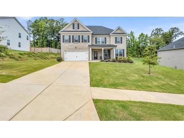 Charming two-story brick home with a well-manicured lawn and a two-car garage at 4323 Cannon Walk, Ellenwood, GA 30294
