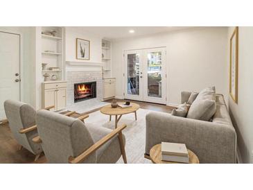 Inviting living room featuring a cozy fireplace and bright french doors at 1150 Collier Nw Rd # A1, Atlanta, GA 30318