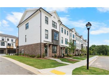 Charming townhome showcases white painted brick and black framed windows at 5440 Howington Ct # 190, Buford, GA 30518