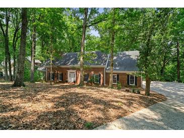Charming single-story brick home surrounded by lush, mature trees in a peaceful setting at 80 Cliffcreek Trce, Atlanta, GA 30350