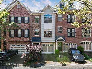 Beautiful brick townhome with attached garage and manicured landscaping at 5523 Glenridge Ne Park, Atlanta, GA 30342