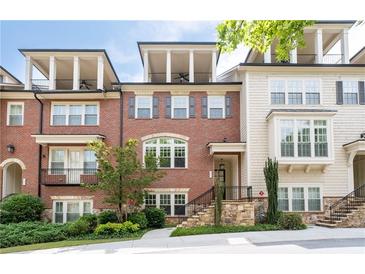Beautiful brick townhome with a balcony and a manicured front yard in a desirable community at 4089 Thorndale Ln # 13, Smyrna, GA 30080