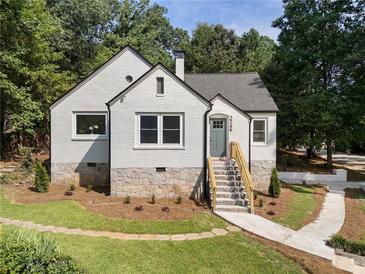 Charming painted brick home with stone foundation and manicured front yard at 2249 Beecher Sw Rd, Atlanta, GA 30311