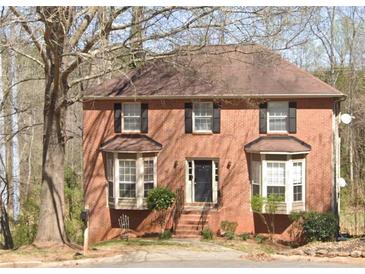 Charming two-story brick home featuring bay windows and a classic black front door at 1537 Mcadoo Sw Dr, Marietta, GA 30064