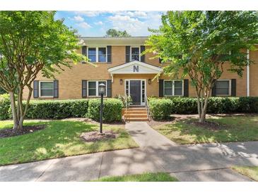 Apartment building with a manicured lawn, sidewalk, and mature trees in a garden-like setting at 3510 Roswell Nw Rd # N3, Atlanta, GA 30305