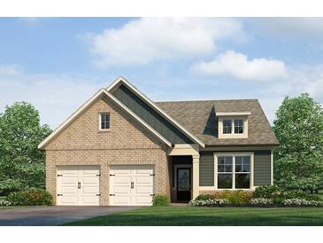 Charming home featuring a two-car garage, brick accents, and a well-manicured lawn at 304 Cedar Hollow Dr Ln, Conyers, GA 30094