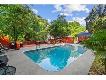 Refreshing backyard pool surrounded by lush greenery and a relaxing patio area at 4648 Danna Dr, Austell, GA 30106