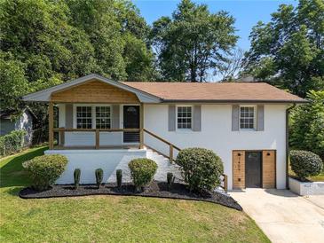 Charming renovated two-story home with modern updates and a lush, landscaped front yard at 1409 Georgia Ave, East Point, GA 30344