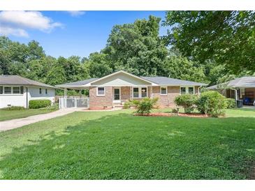 Charming brick home featuring a well-maintained lawn and mature trees in a desirable neighborhood at 2483 Hunting Valley Dr, Decatur, GA 30033