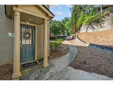 Charming front entrance with a wreath, a 'hello' door mat, and classic architectural pillars at 3048 Briarcliff Ne Rd # 9, Atlanta, GA 30329