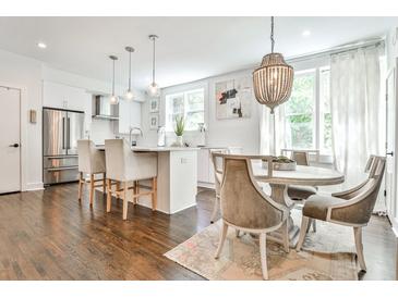 Modern kitchen featuring stainless steel appliances, pendant lighting, and an island with barstool seating at 68 Peachtree Memorial Nw Dr # 68-5, Atlanta, GA 30309