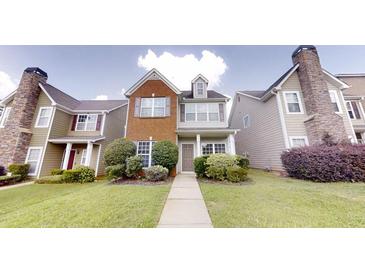 Charming townhome with brick and siding exterior, well-maintained landscaping, and inviting entrance at 2320 Polaris Sw Way, Atlanta, GA 30331